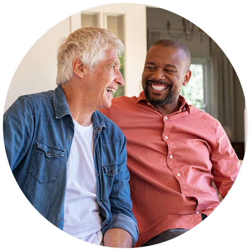 Two men laughing together in conversation.