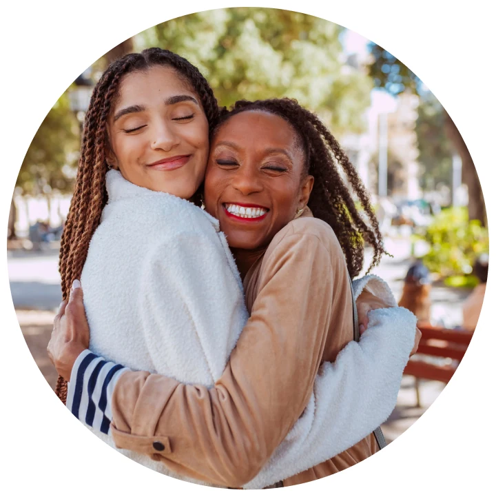Two women embracing and smiling.