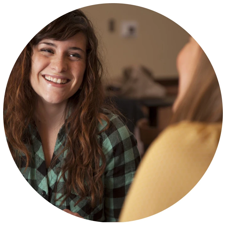 A woman smiling during a conversation.